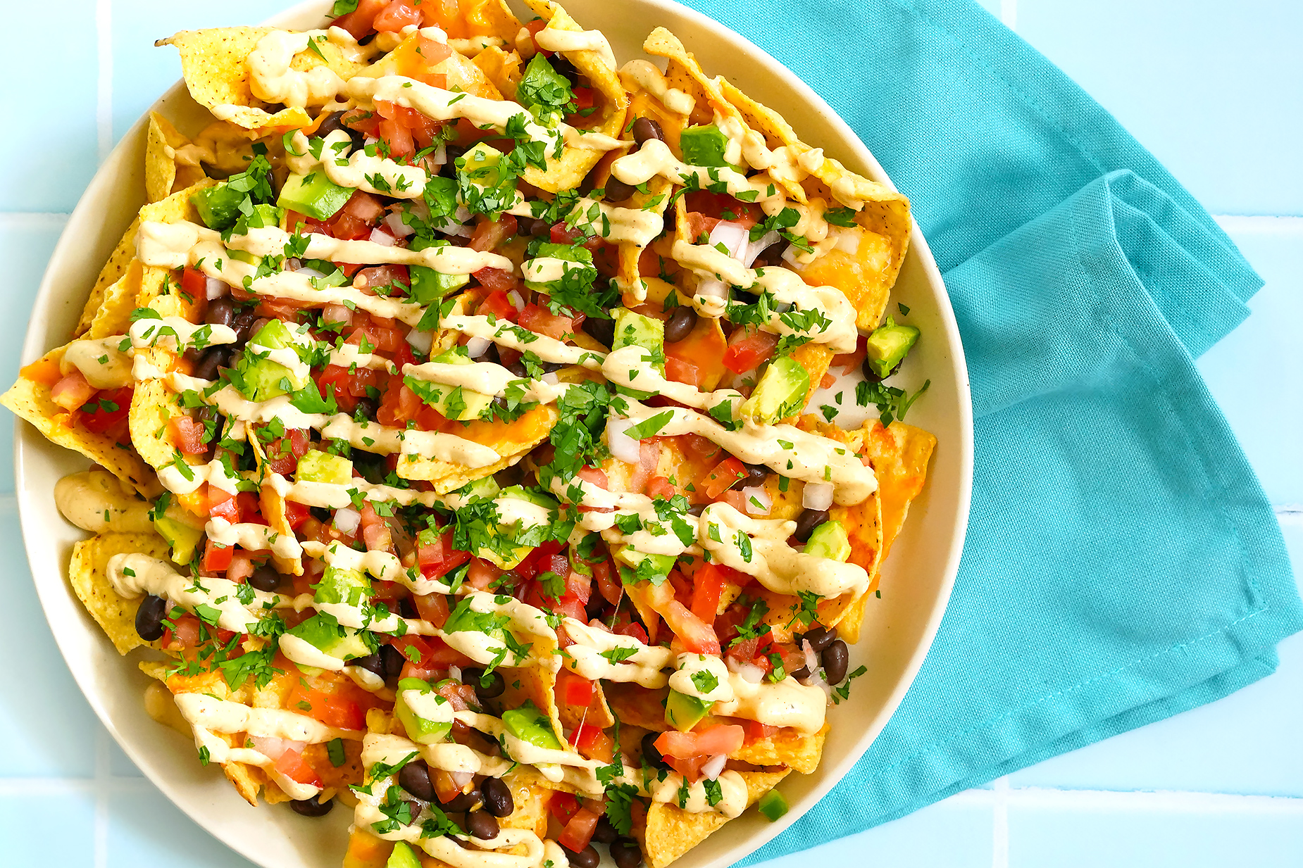SMOKY CHIPOTLE NACHOS TOPPED WITH YUMM SAUCE